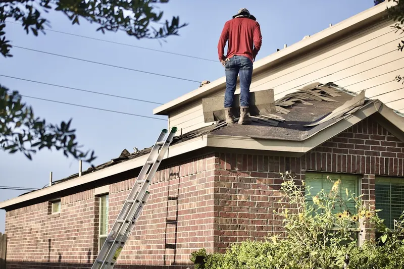 Professional roofer working on a residential roof in Princeton Estates